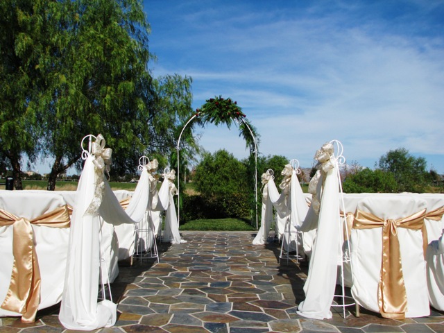 Iron white arch with draping, flower and 6 stand whit draping